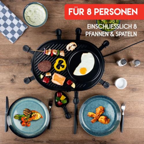 Raclette-Grill für 8 Personen mit Fleisch und Gemüse auf der Grillplatte und Pfännchen für Beilagen, bereit für ein gemeinsames Essen